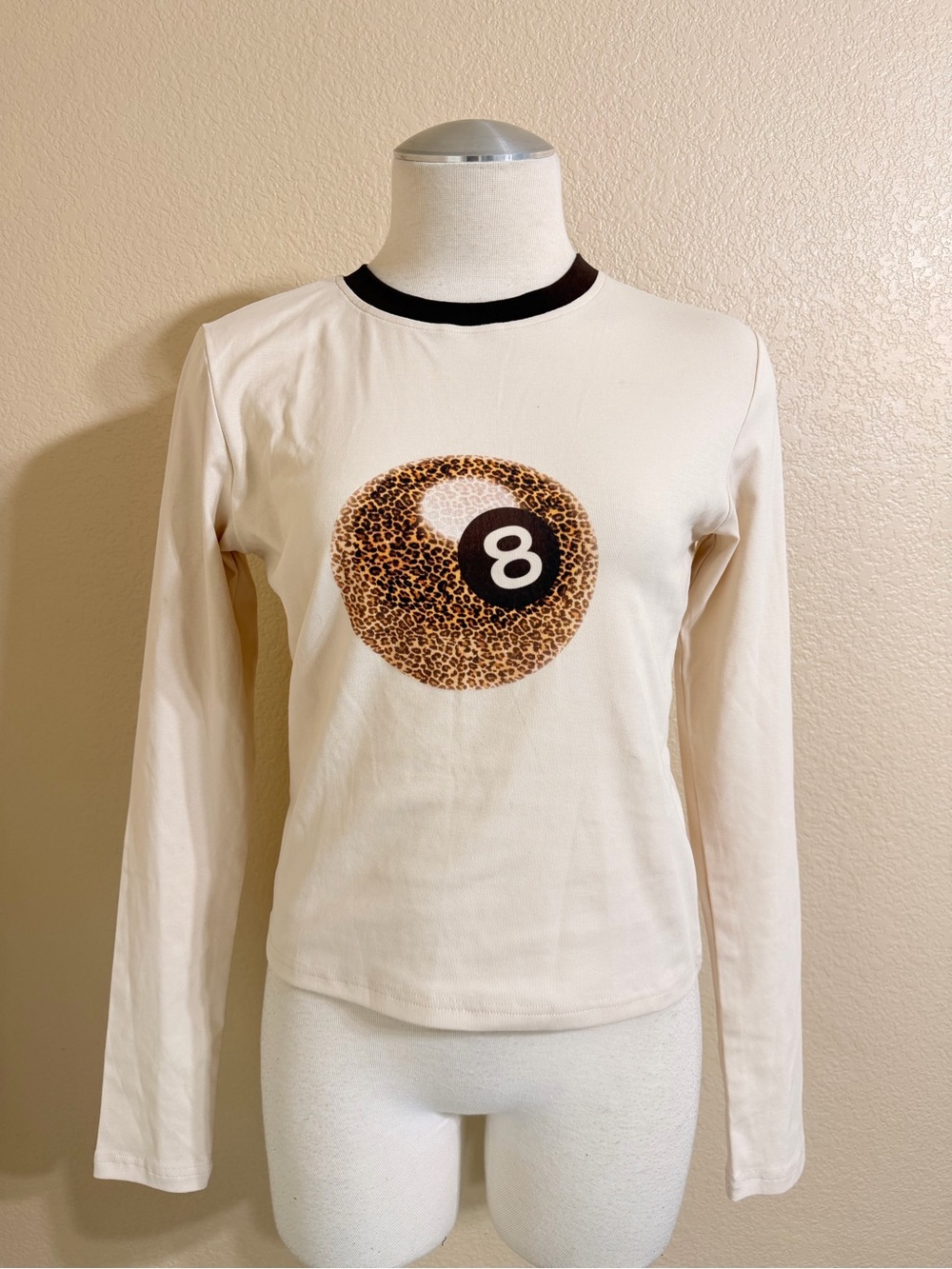 Edikted Cream Long-Sleeve Tee with Leopard 8-Ball Graphic and Black Trim